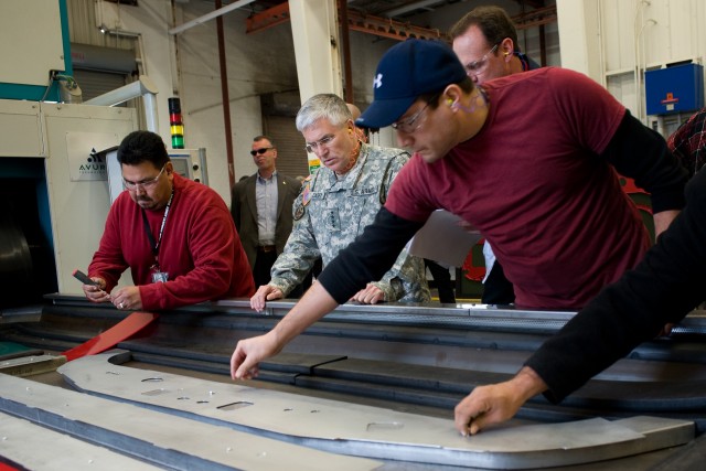 Chief of Staff of the US Army, Gen. George W. Casey Jr.,  observes how UH-60 Helicopter parts are molded during his visit to Corpus Christi Army Depot, TX, Jan. 10, 2011.  Casey toured the facilities and thanked employees for their contributions to U...