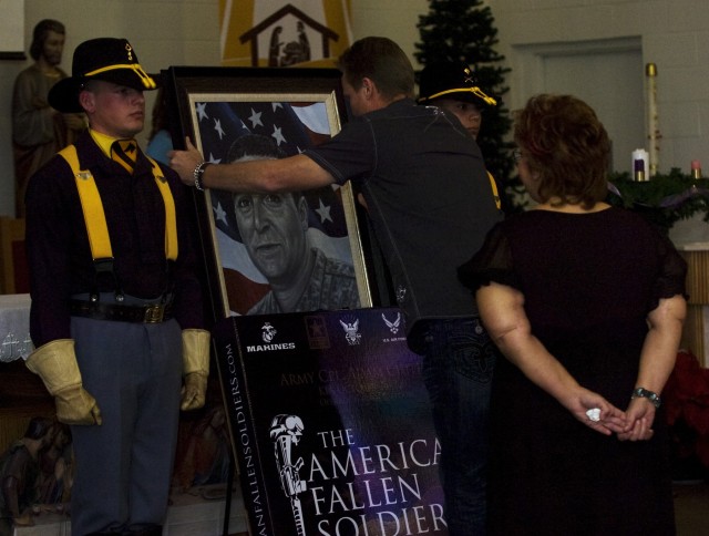 Phil Taylor, artist for and founder of The American Fallen Soldiers Project: Portraits of Patriotism, unveils a portrait of Cpl. Adam Chitjian, 3rd Battalion, 8th Cavalry Regiment, 3rd Brigade Combat Team, 1st Cavalry Division, who was killed in acti...