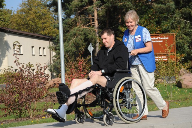 Red Cross volunteer assists wounded warrior