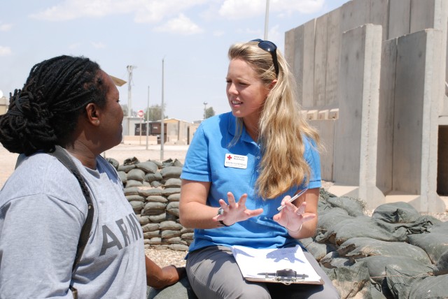 Red Cross staffer speaks with Soldier