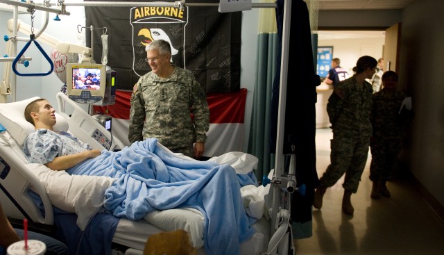 Chief of Staff of the US Army, Gen. George W. Casey Jr.,  talks with a Soldier  while medical staff stand by at Brooks Army Medical Center (BAMC) in Ft. Sam Houston, TX, on Jan. 21, 2011.  Casey visited  BAMC to meet with the institution's...