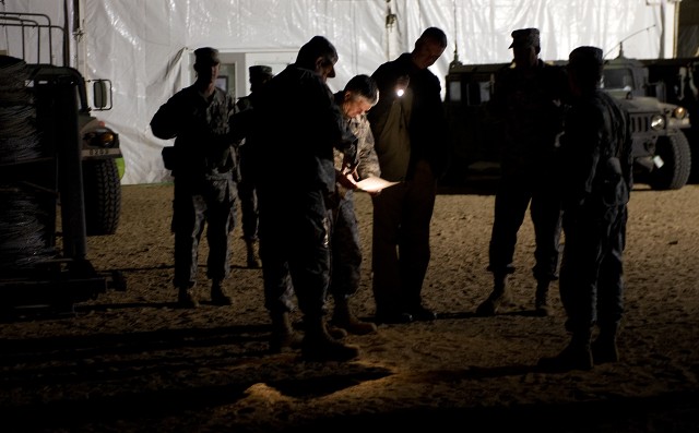 Chief of Staff of the Army Gen. George W. Casey Jr. reviews notes by flashlight while visiting the National Training Center (NTC) in Ft. Irwin, CA, on Jan. 22, 2011.  The mission of the NTC is to provide  realistic, joint and combined arms...