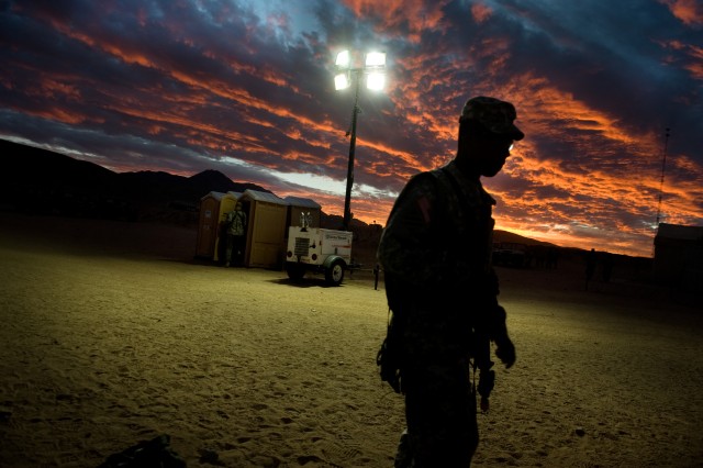 A Soldier walks to his unit's command center during a training exercise at the National Training Center (NTC) in Ft. Irwin, CA, on Jan. 22, 2011.  The mission of the NTC is to provide realistic, joint and combined arms training in multi-national...