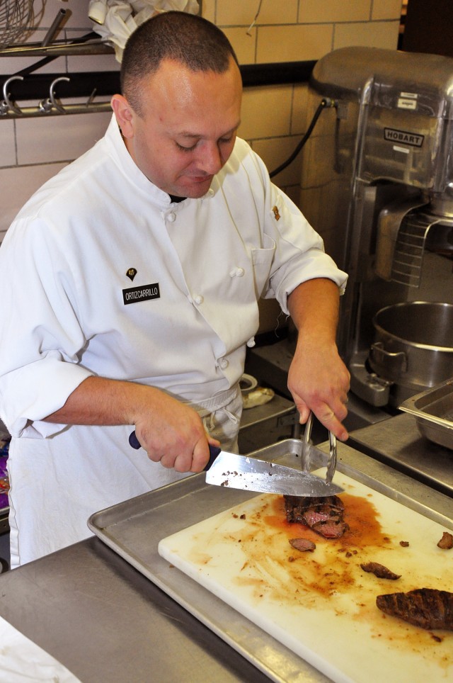 FORT HOOD, Texas-Spc. Diego Ortiz-Carrillo, from Mexico City, Mexico, a field chef team member for Team Hood, slices Texas sirloin for the main course at the Culinary Arts Center, Jan. 20. Team Hood is preparing for the 36th Annual U.S. Army...