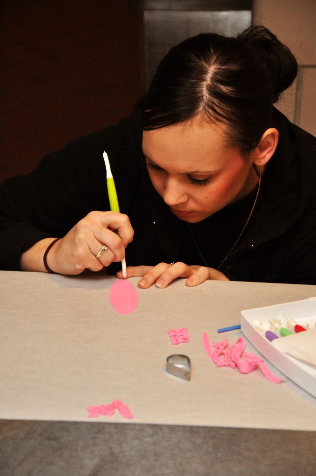 FORT HOOD, Texas-Spc. Katrina Guillen, a Bloomfield, Neb. native, works on creating ballet slippers and bows for one of her petit four projects at the Fort Hood Culinary Arts Center, Jan. 20. A petit four is a tiny cake that is less than an inch and ...