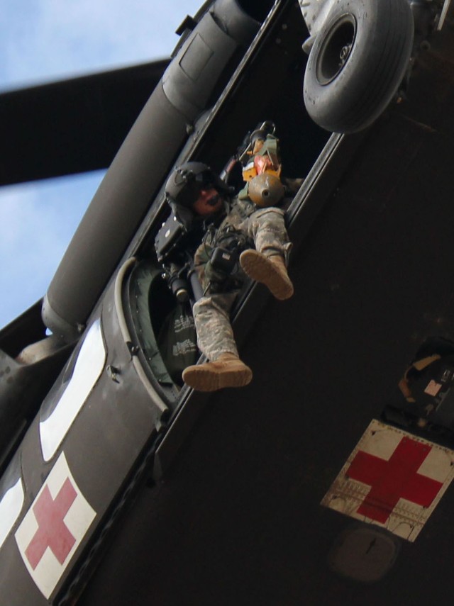 FORT CARSON, Colo.-Staff Sgt. Chad Farris, of Salisbury, N.C., a crew chief from Company C, Task Force Attack, 1st Air Cavalry Brigade, 1st Cavalry Division, looks on from a UH-60A Black Hawk helicopter as he and the rest of the crew prepare to...