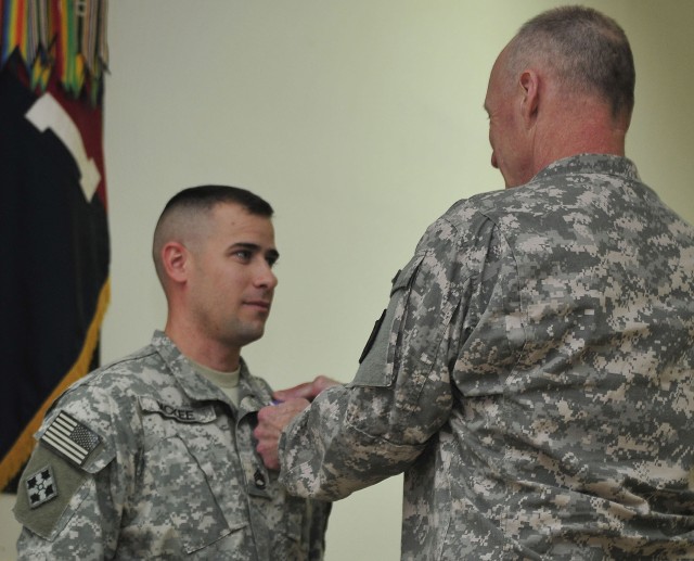 CONTINGENCY OPERATING SITE WARRIOR, Iraq - Lt. Gen. Robert Cone, deputy commanding general, operations, U.S. Forces-Iraq, presents the Purple Heart Award to Sgt. 1st Class Isaac McKee, platoon sergeant, Company B, 2nd Battalion, 12th Cavalry...