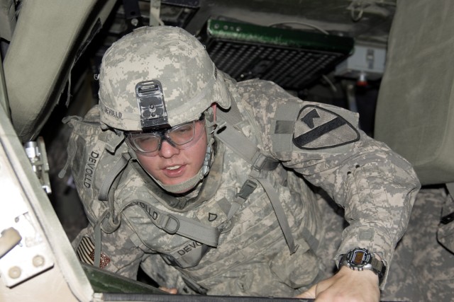 CAMP BUEHRING, Kuwait - Pfc. Robert Devolld, with A Troop, 6th Squadron, 9th Cavalry Regiment, 3rd Advise and Assist Brigade, 1st Cavalry Division, climbs out of a vehicle rollover simulator at Camp Buehring, Kuwait as part of a training event...