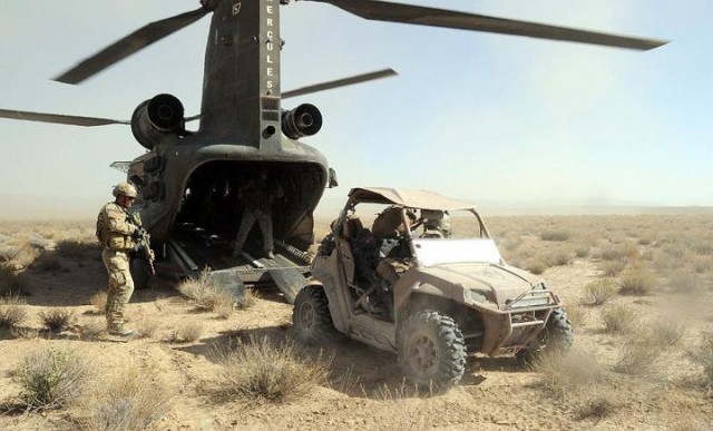 Special Forces Soldiers load ATV onto Chinook