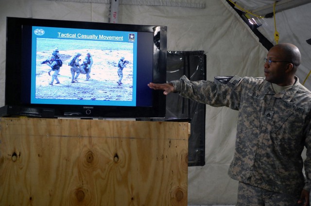 JOINT SECURITY STATION INDIA, Iraq - Staff Sgt. Willie Gray, a combat medic assigned to Company C, 27th Brigade Support Battalion, 4th Advise and Assist Brigade, 1st Cavalry Division, draws Iraqi Security Forces attention to a visual aid during a com...