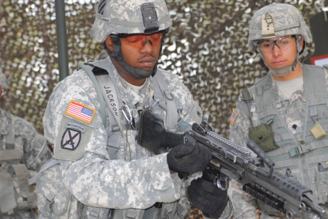 Sgt. Corey Jackson of 1st Battalion, 15th Infantry Regiment, practices checking, loading and correcting malfunctions with the M249 squad automatic weapon Wednesday during rehearsal for this week's Expert Infantryman Badge testing at the Selby Hill Co...