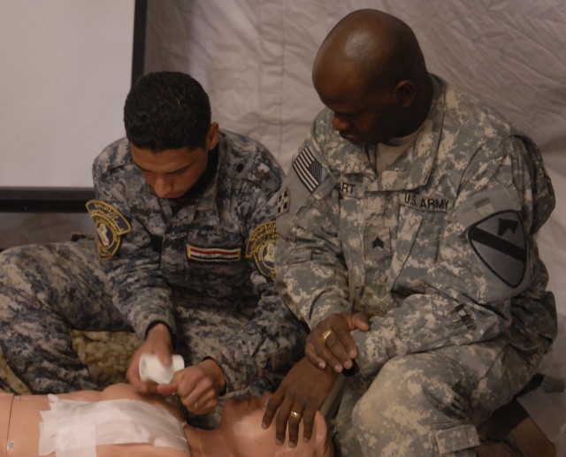 CONTINGENCY OPERATING SITE MAREZ, Iraq - Sgt. Kwame Hart (right), a combat medic section chief assigned to Headquarters and Headquarters Battery, 5th Battalion, 82nd Field Artillery Regiment, 4th Advise and Assist Brigade, 1st Cavalry Division,...