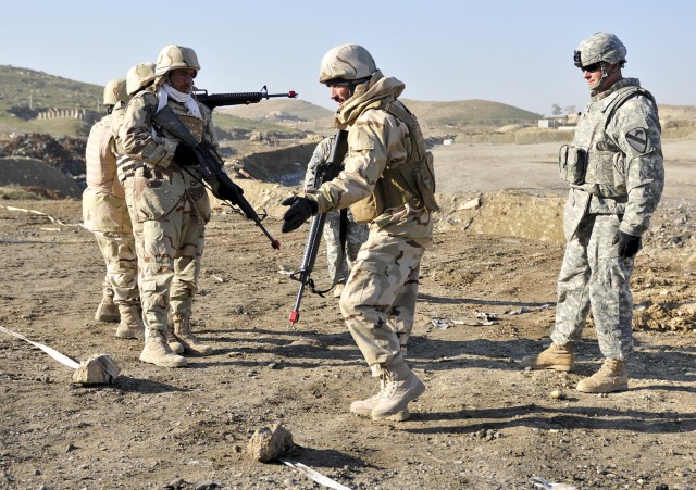 Staff Sgt. Don Gillam (right), a Ghuzlani Warrior Training Center instructor assigned to 1st Squadron, 9th Cavalry Regiment, 4th Advise and Assist Brigade, 1st Cavalry Division, observes Iraqi soldiers with 2nd Battalion, 11th Brigade, 3rd Iraqi...