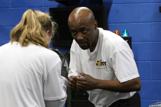 Basheer Abdullah, All-Army Boxing head coach, gives Capt. Rachell Wehrle,  Fort Bliss, Texas, boxing pointers during a practice exercise at Barnes Field House. Abdullah announced his retirement from All-Army Boxing during the camp here that concluded...