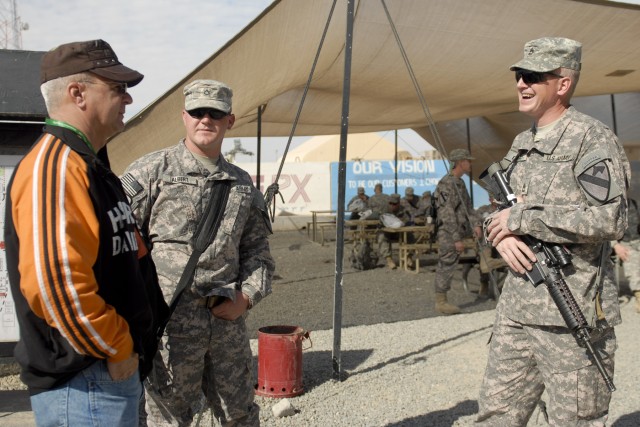 CAMP BUEHRING, Kuwait - Pfc. Brandon Albert (center) and his platoon sergeant Sgt.1st Class Michael Trail, both with C Company, 3rd Brigade Special Troop Battalion, 3rd Advise and Assist Brigade, 1st Cavalry Division meet with Albert's father,...