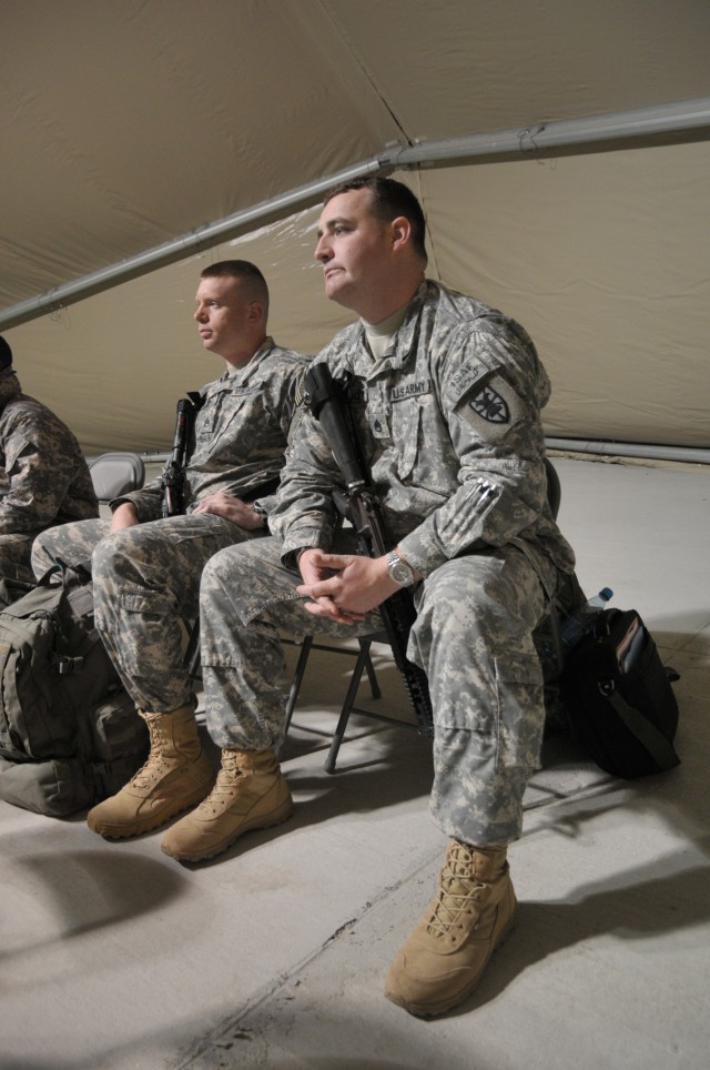 Staff Sgt. Charles Pursley, (foreground) a Special Troops Battalion, 7th Sustainment Brigade movement control Noncommissioned Officer, and Staff Sgt. Douglas Ferguson, (left) a 7th Sus. Bde. Personal Security Detachment Noncommissioned Officer,...