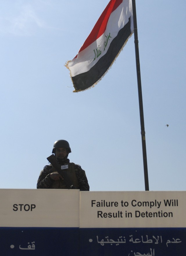 CONTINGENCY OPERATING SITE MAREZ, Iraq - An Iraqi policeman assigned to 3rd Federal Police Division provides security from a guard tower during checkpoint training, Feb. 17, 2011. Soldiers assigned to 5th Battalion, 82nd Field Artillery Regiment, 4th...