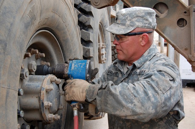 JOINT SECURITY STATION INDIA, Iraq - Sgt. Lonnie Malone, a wheeled vehicle mechanic assigned to Headquarters and Headquarters Company, 2nd Battalion, 7th Cavalry Regiment, 4th Advise and Assist Brigade, 1st Cavalry Division, loosens the lugs on an M9...