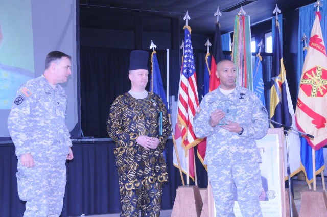 Col. John M. Spiszer, Joint Multinational Training Center commander (left) and Command Sgt. Maj. Thomas R. Capel, Command Sergeant Major U.S. Army Europe, (right) present Master Sgt. Christopher T. Mulvihill with the Equal Opportunity Advisor of 2010...