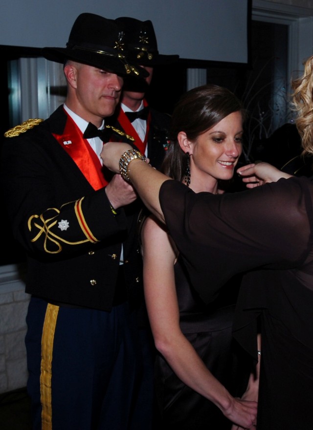 BELTON, Texas - Ashley Allen (center), spouse of Capt. Samuel Allen, 3rd Battalion, 82nd Field Artillery Regiment, 2nd Brigade Combat Team, 1st Cavalry Division, receives the Order of Molly Pitcher award from Lt. Col. Nate Cook, commander of the...