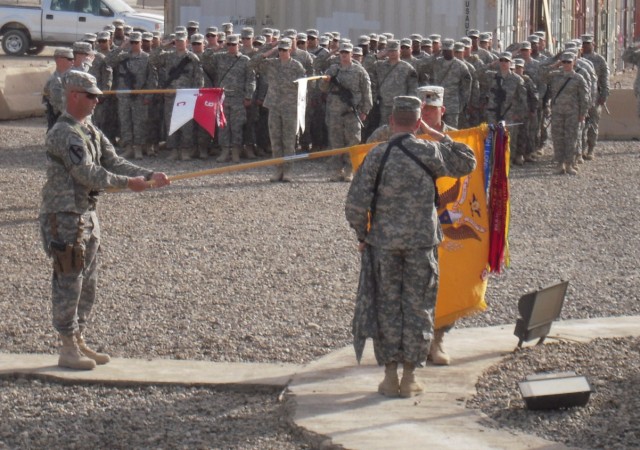 BAGHDAD, Iraq -Lt. Col. Cameron Cantlon, commander of 6th Squadron, 9th Cavalry Regiment, 2nd Advise and Assist Brigade, 1st Infantry Division, United States Division - Center, and Command Sgt. Maj. Richard Burnette salute the unit's colors Feb....