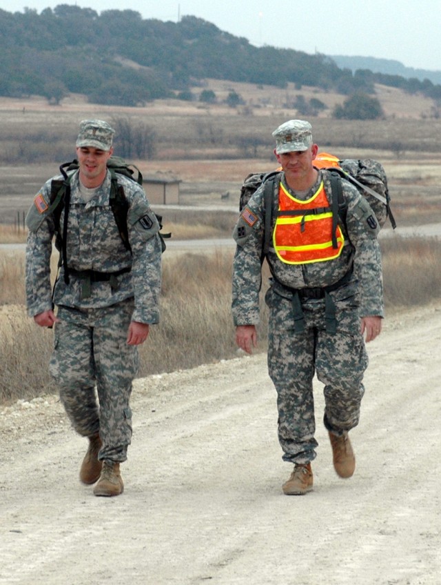 FORT HOOD, Texas-Maj. Raymond Jones (right), of Glenrose, Texas, and 2nd Lt. Nicholas Hughes focus on the walk during their 22 mile ruck march on the tank trail here, Feb. 23. The Soldiers are practicing for the 22nd annual Bataan Memorial Death...