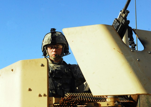 FORT HOOD, Texas - Pfc. Raben Meza, a Boise, Idaho native and a fire support specialist with 3rd Battalion, 82nd Field Artillery Regiment, 2nd Brigade Combat Team, 1st Cavalry Division, mans the gun on an armored vehicle during gunnery training on Fo...