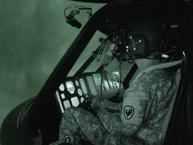 Kentucky National Guard Aviators fly one of the record 36 mission runs for the Air Soldier System situational awareness technologies being tested in the Battlefield Highly Immersive Virtual Environment Laboratory.  The co-pilot pictured here was assi...
