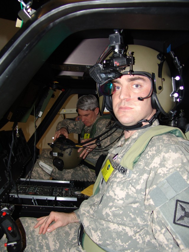 Chief Warrant Officer 3 Kevin Keith, a Kentucky National Guard Aviator, wearing a tactical situational awareness system waist belt, shoulder straps and seat pan waits as Chief Warrant Officer 2 Justin Frye completes suiting up for one of their organi...