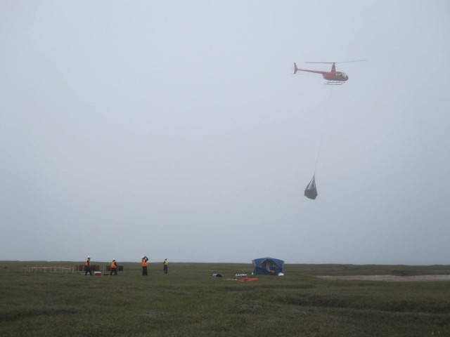 Transporting a sling load of drums back to Kaktovik