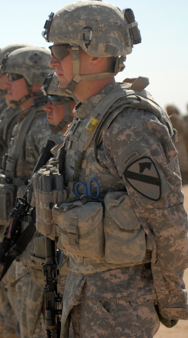 CONTINGENCY OPERATING BASE ADDER, Iraq - Capt. Bryan Herzog, the commander for B Company, 1st Battalion, 12th Cavalry Regiment, 3rd Advise and Assist Brigade, 1st Cavalry Division, stands in a formation, March 2, to celebrate the completion of an ite...