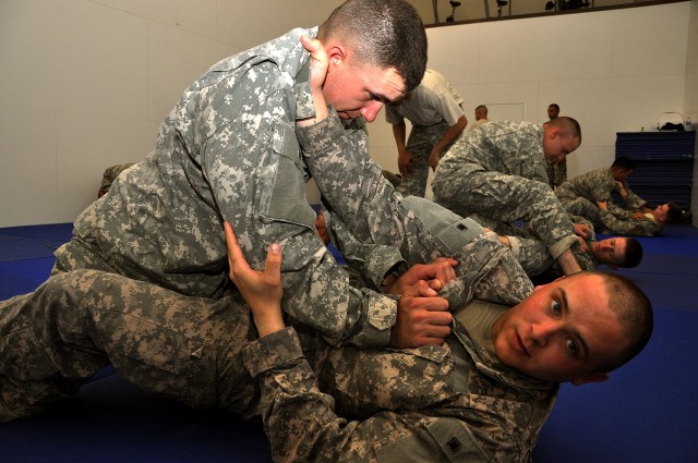 FORT HOOD, Texas-Spc. Dustin Weddle (bottom), attempts to roll Pfc. Ryan Herold during Deep Strike's level two combatives certification training. Both Soldiers, with  67th Forward Support Company, 2nd Battalion, 20th Field Artillery Regiment, will be...