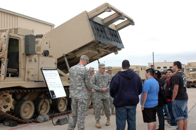 FORT HOOD, Texas-Soldiers from Battery B, 2nd Battalion, 20th Field Artillery Regiment, 41st Fires Brigade, show Junior Reserve Officer Training Corp cadets from A.J. Moore Academy, the multiple launch rocket system during their visit March 4. The...