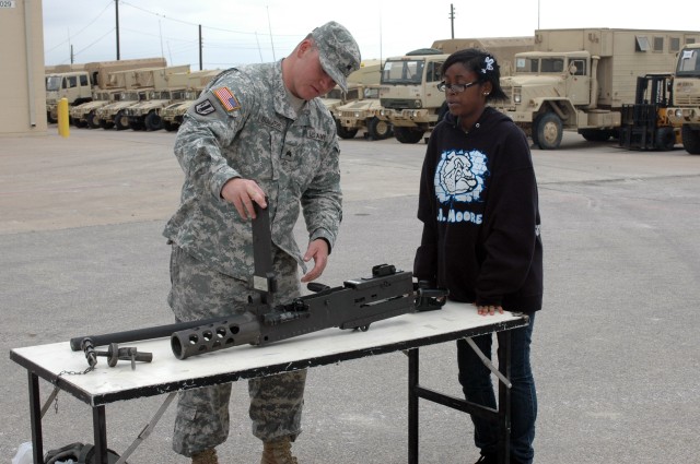 FORT HOOD, Texas-Sgt. David Summers, from Emmett, Idaho, a multiple launch rocket system crew chief for Battery B, 2nd Battalion, 20th Field Artillery Regiment, 41st Fires Brigade, takes apart the .50 caliber machine gun to show Kennedy Haynes, a...
