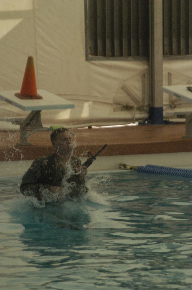 FORT IRWIN, Calif.- A Soldier enters the water during the Combat Water Survival Test portion of the Pre-Ranger Assessment Course at Fort Irwin, Calif., Feb. 28. Soldiers participat