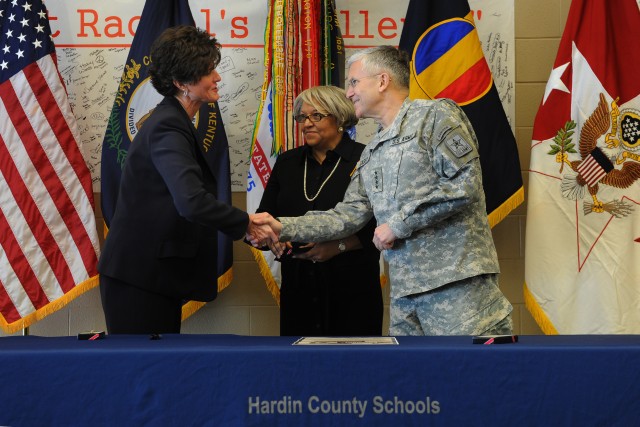 (left) Hardin County Superintendent Nanette Johnson, National Association of State Boards of Education Executive Director Brenda Welburn and Chief of Staff of the Army Gen. George W. Casey Jr. shake hands after they sign a Community Covenant honoring...