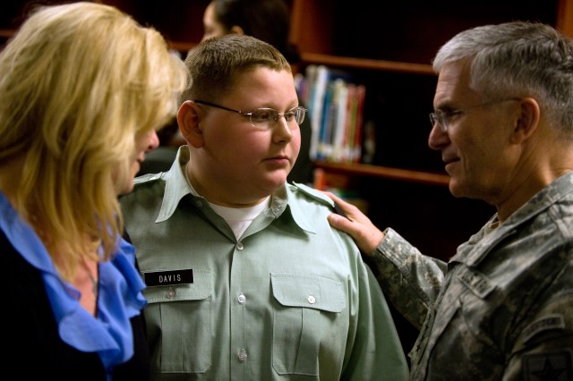 Chief of Staff of the Army Gen. George W. Casey Jr. talks with project PASS student, Austin Davis, and his mother at North Middle School in Radcliff, Ky., on Mar. 11, 2011. Project PASS - Partnership for All Student Success - is an umbrella for high ...