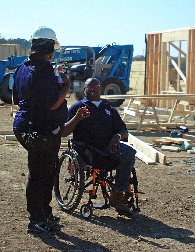 FORT HOOD, Texas - Sgt. 1st Class Charles Armstead, a wounded Soldier with the Warrior Transition Brigade and formerly with the 1st Cav. Div., talks with his wife, Tonia, March 11, about the specifics of their new home being built. The couple will...
