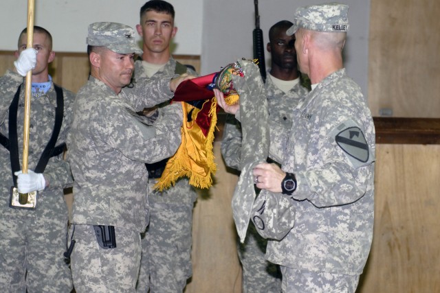 CONTINGENCY OPERATING BASE ADDER, Iraq - Col. Douglas Crissman and Command Sgt. Maj. Ronnie Kelley with 3rd Advise and Assist Brigade, 1st Cavalry Division uncase the brigade's colors at a transfer of authority ceremony March 12. The Greywolf Brigade...