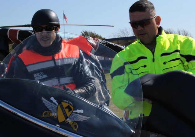 FORT HOOD, Texas - Command Sgt. Maj. Glen Vela, 1st Air Cavalry Brigade, interacts with Theo Rossi, who stars in the show "Sons of Anarchy" prior to the commencement of a motorcycle mentorship ride, March 10. Kim Coates, also from the show, accompani...