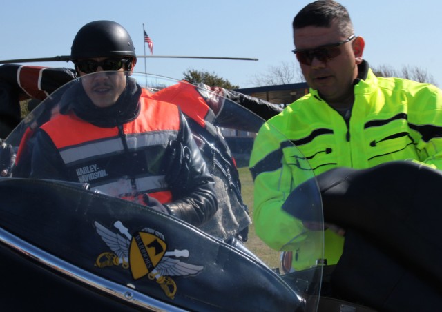 FORT HOOD, Texas - Command Sgt. Maj. Glen Vela, 1st Air Cavalry Brigade, interacts with Theo Rossi, who stars in the show "Sons of Anarchy" prior to the commencement of a motorcycle mentorship ride, March 10. Kim Coates, also from the show,...