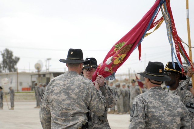 CONTINGENCY OPERATING SITE MAREZ, Iraq - Col. Brian Winski, commander of 4th Advise and Assist Brigade, 1st Cavalry Division, passes the 27th Brigade Support Battalion colors to incoming commander Lt. Col. Elward Cortez, during a Change of Command ce...