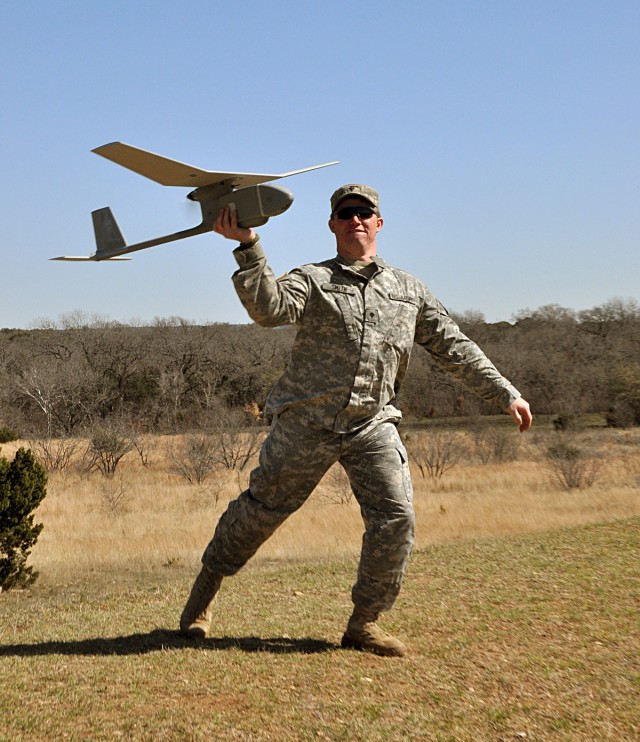 Spc. Thomas Smith, a tanker with Company B, 1st Battalion, 8th Cavalry Regiment, 2nd Brigade Combat Team, launches the Raven RQ-11B unmanned aerial vehicle during the re-certification training at House Creek Assault Course, Fort Hood, Texas, March...