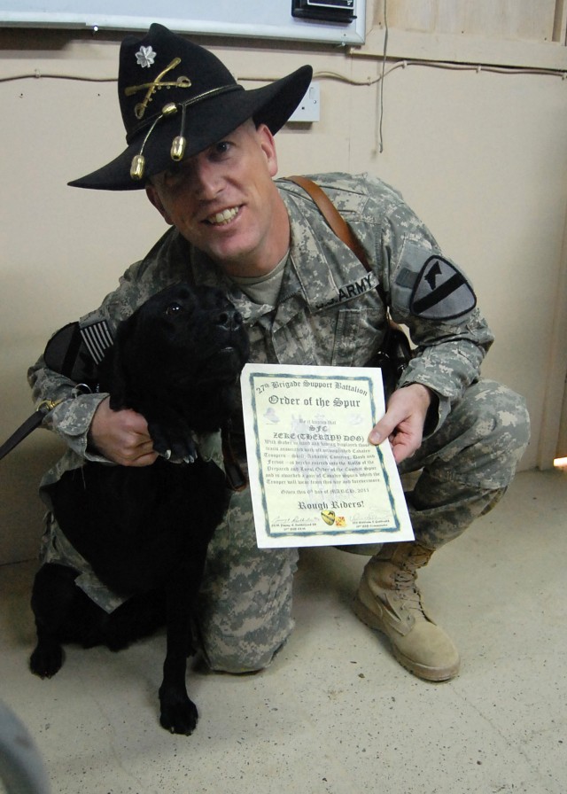 Sgt. 1st Class Jonathan Zeke, a combat stress-relief dog assigned to 85th Medical Combat Stress Control Detachment, is inducted into the Order of the Spur by Lt. Col. Paul Reese, deputy commander of 4th Advise and Assist Brigade, 1st Cavalry Division...