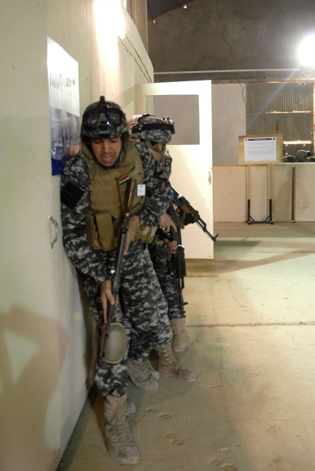 CONTINGENCY OPERATING SITE MAREZ, Iraq - Iraqi policemen assigned to 3rd Federal Police Division, stack on a wall prior to clearing a room at the Ghuzlani Eagle Training Center, March 9, 2011. Twenty-six policemen trained with Soldiers assigned to 5t...