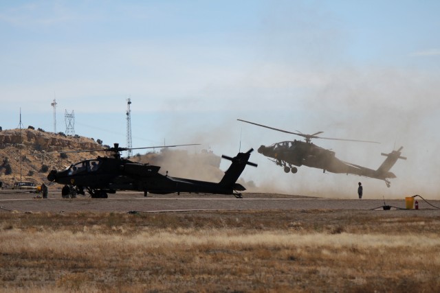 An AH-64D Apache helicopter from Task Force Spearhead 1st Air Cavalry Brigade, 1st Cavalry Division, raises dust as it lands during high altitude, mountain environmental training near Fort Carson, Colo., Feb., 21. The pilots and crew chiefs of the ta...