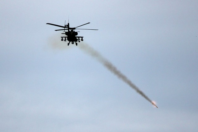 An AH-64D Apache helicopter from Task Force Spearhead 1st Air Cavalry Brigade, 1st Cavalry Division, fires a rocket during a gunnery at high altitude, mountain environmental training near Fort Carson, Colo., March, 5. The pilots and crew chiefs of th...