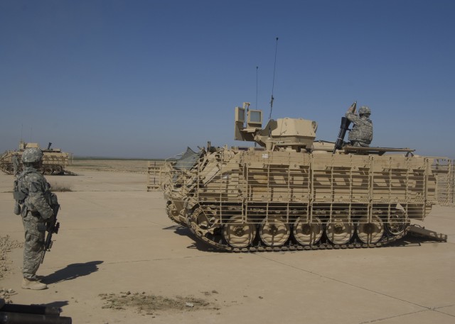 CONTINGENCY OPERATING SITE MAREZ, Iraq - Sgt. Andrew Harris, a mortar section sergeant assigned to Headquarters and Headquarters Company, 2nd Battalion, 7th Cavalry Regiment, 4th Advise and Assist Brigade, 1st Cavalry Division, watches as a...