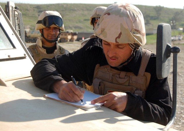 CONTINGENCY OPERATING SITE MAREZ, Iraq - Spc. Ahmed Abeulkadhem, an Iraqi soldier assigned to 3rd Battalion, 11th Brigade, 3rd Iraqi Army Division, annotates a tactical vehicle's deficiencies on a preventive maintenance checks and services...
