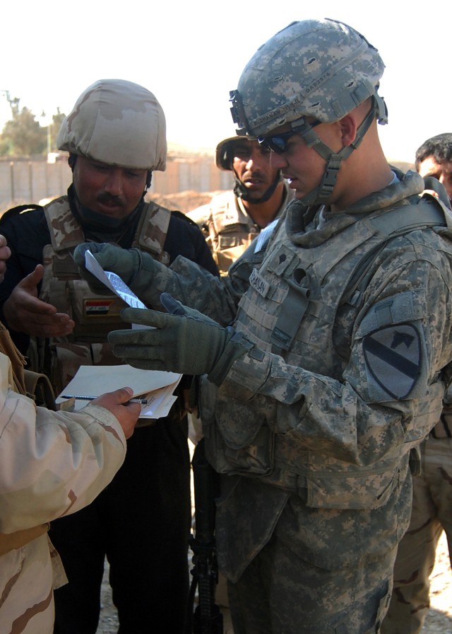 CONTINGENCY OPERATING SITE MAREZ, Iraq - Spc. Alex Buchanan, a mechanic from Newnan, Ga., assigned to Troop D, 1st Squadron, 9th Cavalry Regiment, 4th Advise and Assist Brigade, 1st Cavalry Division, reviews a equipment inspection and maintenance...
